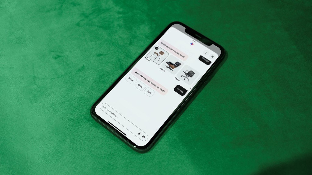 Phone on green velvet showing the eBay AI shopping agent asking about chair styles and colors