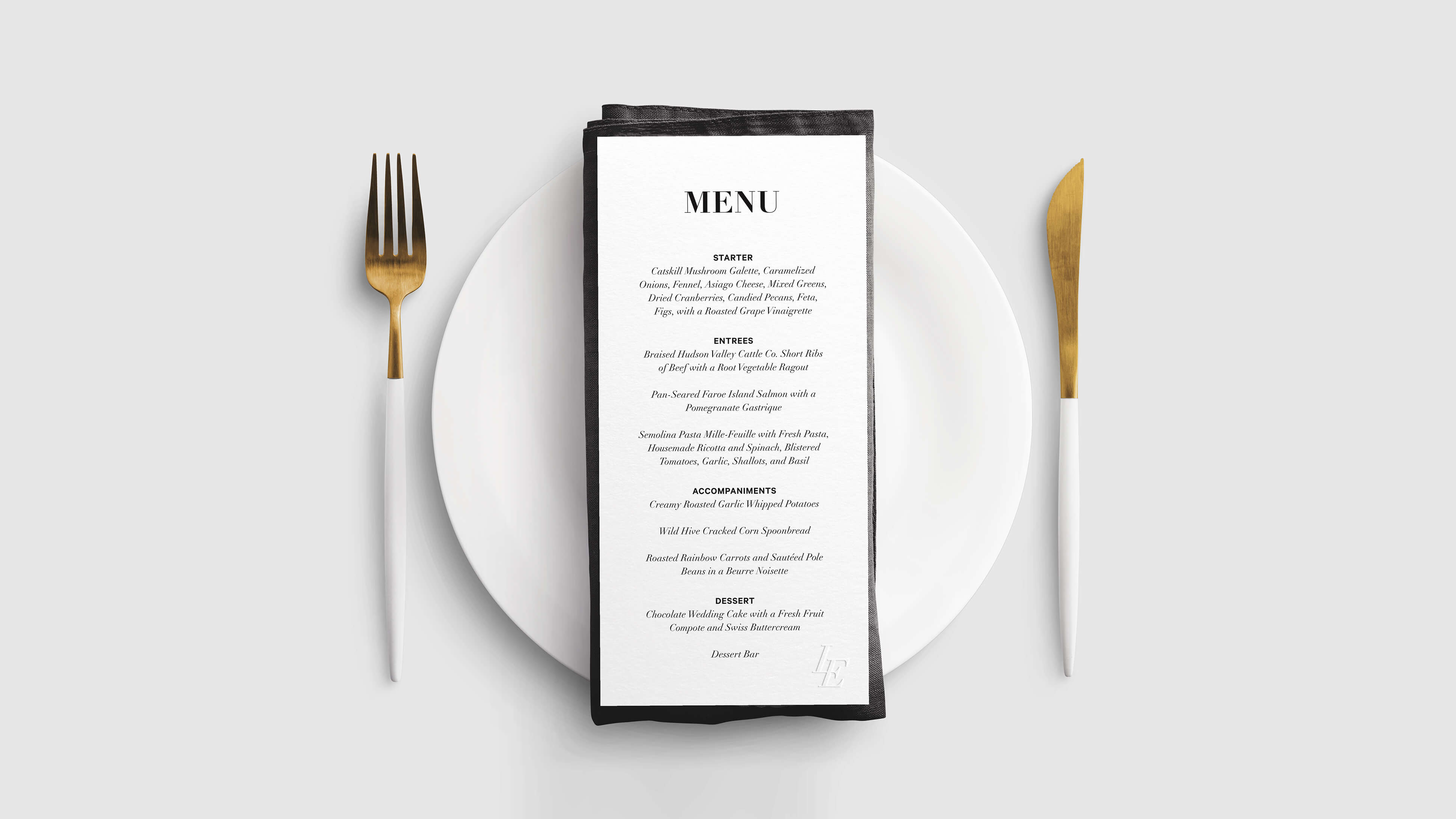 Custom dinner menu embossed with the LE monogram